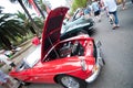 Red Vintage car opens the hood showing its engine at Classic motor show on Australia day.